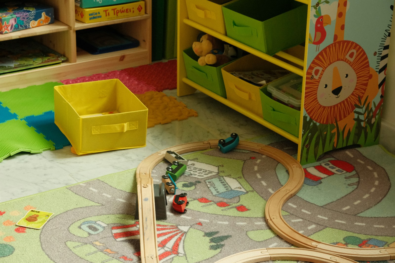 A playroom with bright fabric storage bins and a wooden toy train